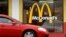 FILE - A car is seen moving through a McDonald's drive-through window line, in Springfield, Illilois.