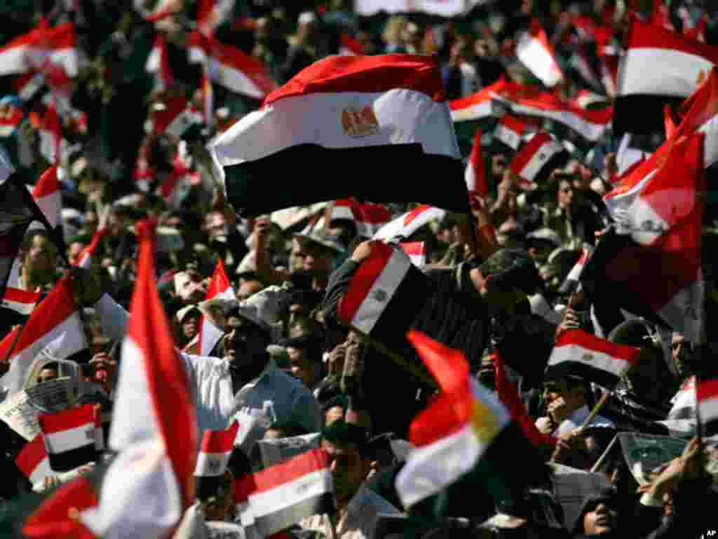 On February 18, 2011, tens of thousands of Egyptians, some waving the national flag, gather in Tahrir square to pray and celebrate the fall of the regime of former President Hosni Mubarak, and to maintain pressure on the current military rulers. (AP)
