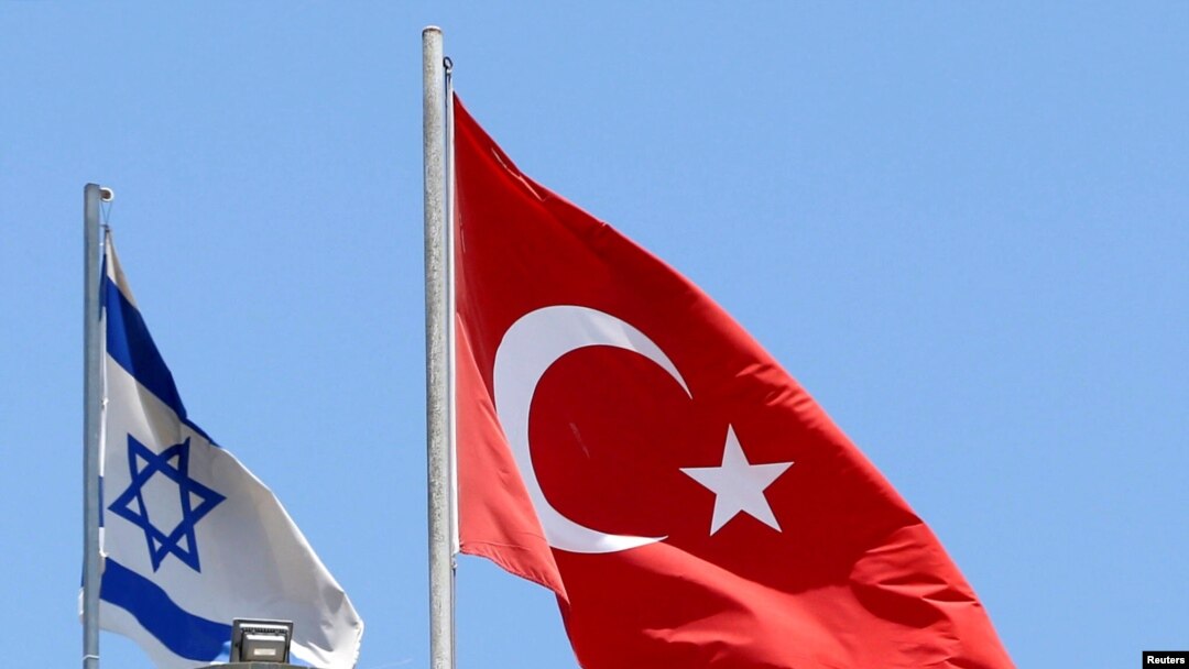 FILE - A Turkish flag flutters atop the Turkish embassy as an Israeli flag is seen nearby, in Tel Aviv, Israel, June 26, 2016. 