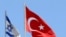 FILE - A Turkish flag flutters atop the Turkish embassy as an Israeli flag is seen nearby, in Tel Aviv, Israel, June 26, 2016.
