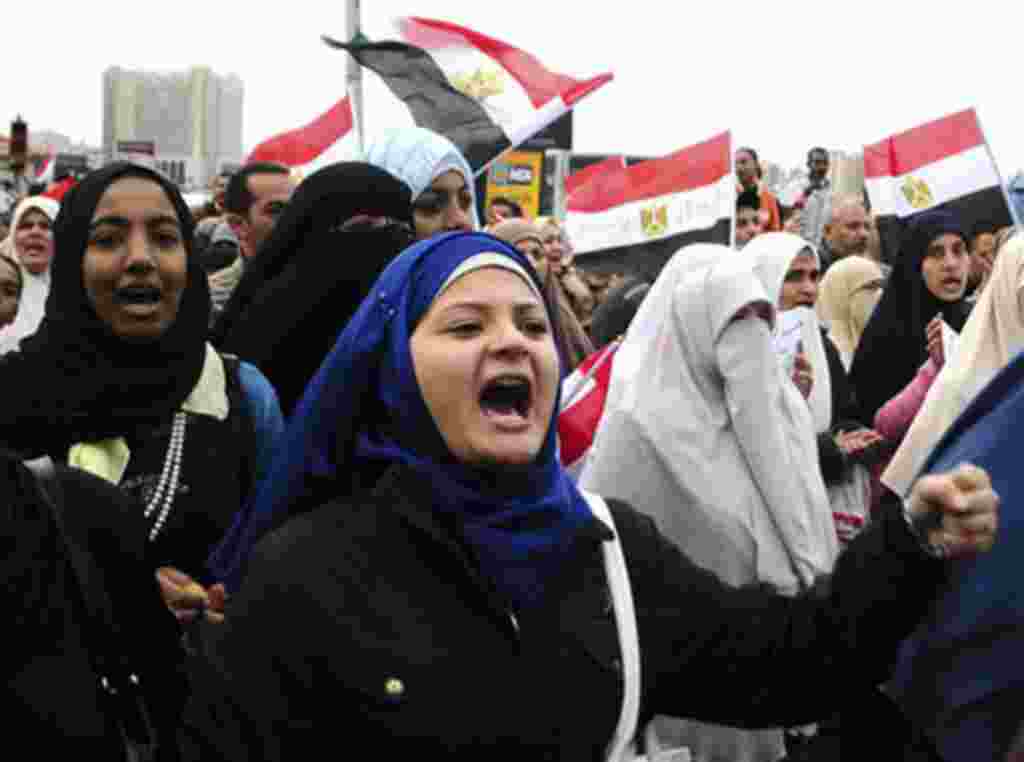 Egyptian anti-Mubarak protesters shout slogans as they march in Alexandria, Egypt, Saturday, Feb. 5, 2011