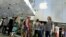 People wait in line as the Apple iPhone 6s and 6s Plus go on sale at an Apple Store in Los Angeles, California Sept. 25, 2015.