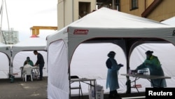 Medical workers and members of the public are seen at a pop-up testing center for the coronavirus disease (COVID-19) in Sydney, Australia, Aug. 12, 2020.