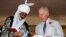 FILE - Britain's Prince Charles stands with the Emir of Kano Lamido Sanusi as they look at a book during his meeting with Traditional Leaders at the British High Commission residence in Abuja, Nov. 6, 2018. 