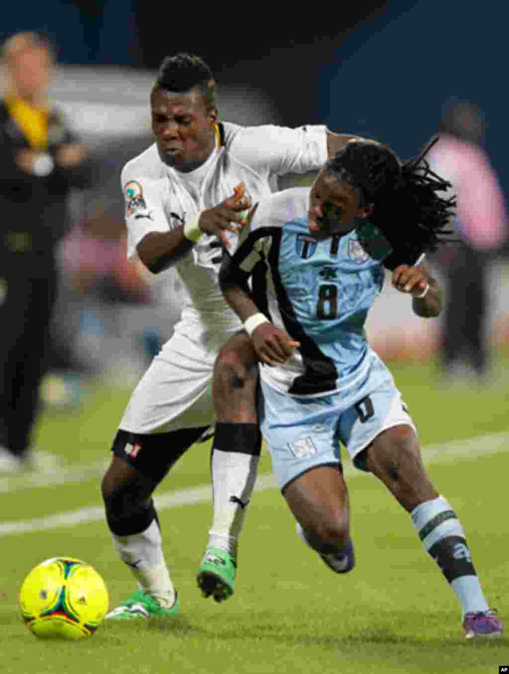 Ghana's Asamoah Gyan challenges Emmanuel Agyemang-Badu of Botswana during their African Cup of Nations Group D soccer match in FranceVille Stadium
