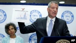 New York City Mayor Bill de Blasio holds up a chart documenting the cases of Legionnaires' disease while speaking to reporters at Lincoln Hospital in the Bronx borough of New York, Aug. 4, 2015.