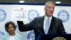 New York City Mayor Bill de Blasio holds up a chart documenting the cases of Legionnaires' disease while speaking to reporters at Lincoln Hospital in the Bronx borough of New York, Aug. 4, 2015.