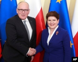 FILE - Poland's Prime Minister Beata Szydlo, right, and EU Commission Vice President Frans Timmermans before talks on ways of ending Poland's political conflict that has strained ties with Brussels, in Warsaw, Poland, May 24, 2016.