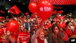 Supporters of the Social Democratic Party (SDP) wave flags and balloons during a final pre-election rally in Sarajevo, Bosnia, Oct. 9, 2014. 