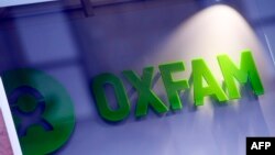FILE - An Oxfam logo is seen on one of the organization's bookshops in Glasgow, Scotland, Feb. 10, 2018.
