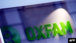 FILE - An Oxfam logo is seen on one of the organization's bookshops in Glasgow, Scotland, Feb. 10, 2018.