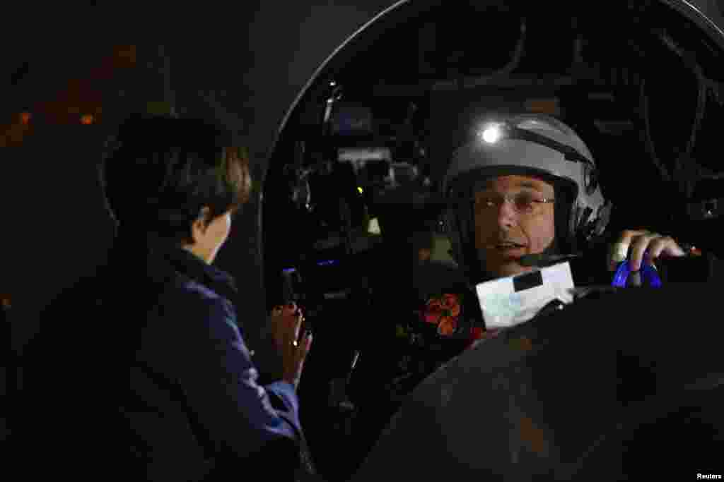 Michele Piccard (L), wife of Solar Impulse pilot Bertrand Piccard, waves goodbye before Bertrand takes off from Moffett Field abroad a sun-powered aircraft to begin the first leg of his 2013 Across America Mission in Mountain View, California May 3, 2013.
