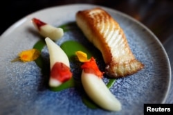 A dish of halibut is served at Chef Christopher Haatuft's restaurant Lysverket in Bergen, Norway July 31, 2018.