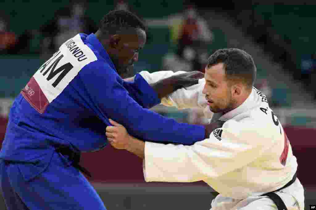 Steven Mungandu of Zambia, left, and Adrian Gomboc of Slovenia compete during their men&#39;s -66kg round of 32 judo match at the 2020 Summer Olympics, Sunday, July 25, 2021, in Tokyo, Japan. (AP Photo/Vincent Thian)