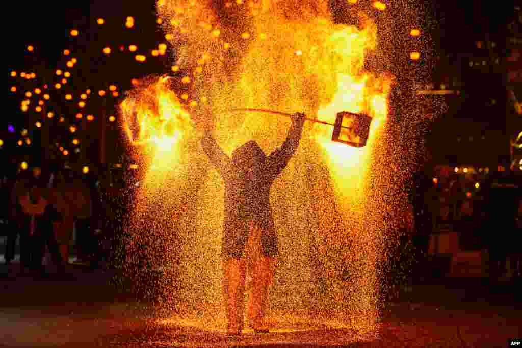 A folk performer sprays molten metal during a show in Xingyi, in China&#39;s southwest Guizhou province on Jan. 22, 2025, during the celebrations of the Lunar New Year which starts on Jan. 29.