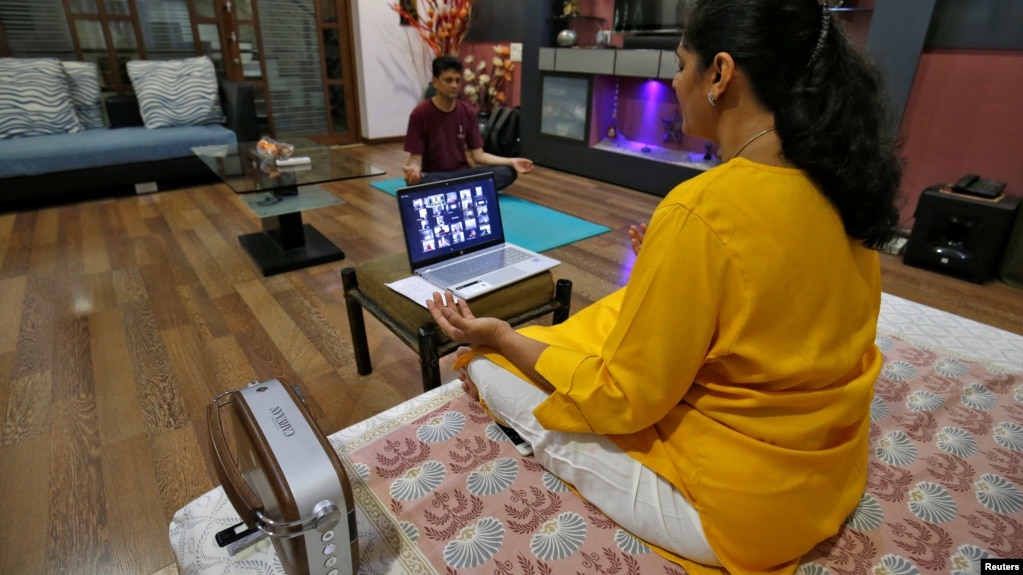 Yoga often involves deep breathing. In Ahmedabad, India, a woman takes an online yoga class in her house on International Yoga Day during the coronavirus outbreak, June 21, 2020. (Reuters Photo/Amit Dave)