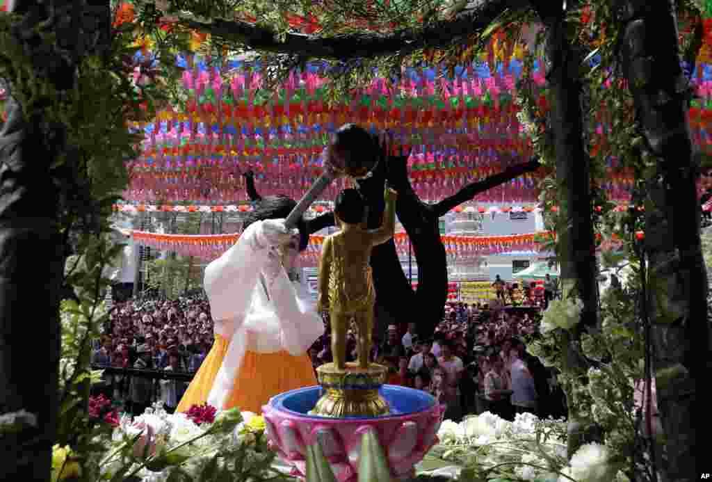 A South Korean believer pours water on a small statue of Buddha to celebrate Buddha&#39;s birthday at Jogye temple in Seoul, South Korea.