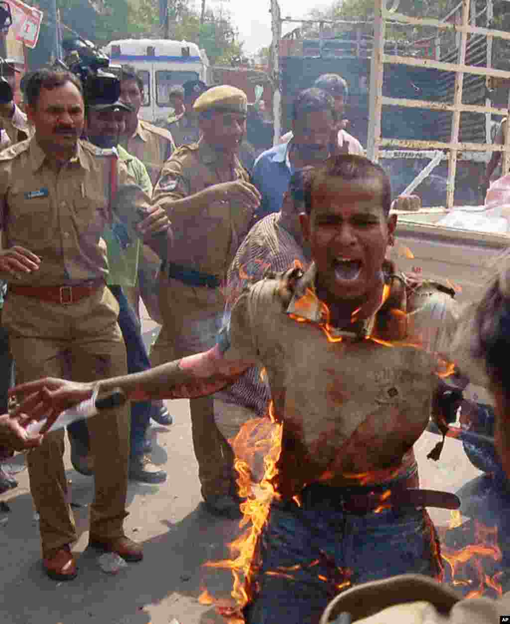 Indian student Yadaiah reacts as he immolates himself during a protest in Hyderabad. A student tried to set himself ablaze as fresh demonstrations erupted in southern India calling for the creation of a new state. The 19-year-old student was in critical c