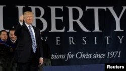 FILE - U.S. President Donald Trump gestures before delivering the keynote address at Liberty University's commencement in Lynchburg, Va., May 13, 2017. The university is producing a movie about a prophecy concerning Trump's election.