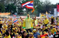 FILE - In this Feb. 4, 2006, file photo, Thai protesters wave flags and cheer during a rally opposing Prime Minister Thaksin Shinawatra at the Royal Plaza in Bangkok, Thailand. (AP Photo/Sakchai Lalit, File)