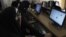 FILE - Pakistani students try to access YouTube in Karachi, Sept. 5, 2013. Pakistan removed a ban on YouTube after the Google-owned video-sharing website launched a version that allows the government to remove material it considers offensive.