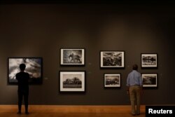 People attend an exhibition of Brazilian photographer Sebastiao Salgado titled 'The World Through His Eyes' at the Bangkok Art and Culture Center in Bangkok, Thailand, Feb. 10, 2017.