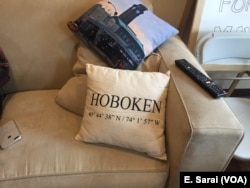 A pillow on the couch of Michael DeFusco’s campaign headquarters boasts the city’s coordinates.