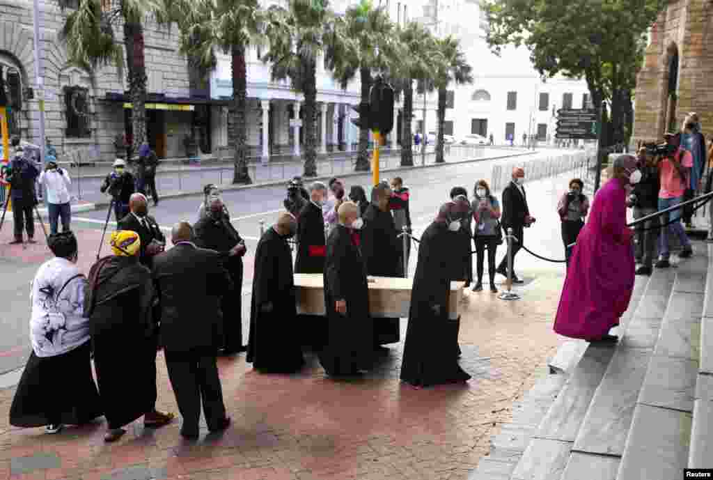 Archbishop of Cape Town Thabo Makgoba walks in front of the casket containing the body of Archbishop Desmond Tutu during arrival at St. Georges cathedral for his lying in state, in Cape Town, South Africa.