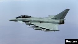 FILE - A British Royal Air Force Typhoon aircraft in flight during a mission over central Iraq, Sept. 21, 2016. 