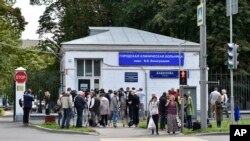 FILE - Journalists gather at a hospital where Russian opposition leader Alexei Navalny had been hospitalized, in Moscow, July 29, 2019. 