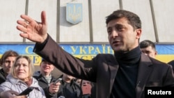 FILE - Volodymyr Zelenskiy, a candidate in Ukraine's upcoming presidential elections who came to fame as TV comic, speaks after submitting registration documents to the Central Election Commission, in Kyiv, Ukraine, Jan. 25, 2019. Zelenskiy is the front-runner in many polls.