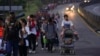 Migrants walk along the Huixtla highway hoping to reach Mexico's northern border and ultimately the United States, in Huehuetan, southern Mexico, Nov. 6, 2024. 