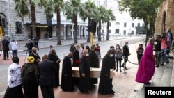 Archbishop of Cape Town Thabo Makgoba walks in front of the casket containing the body of Archbishop Desmond Tutu during arrival at St. Georges cathedral for his lying in state, in Cape Town, South Africa.