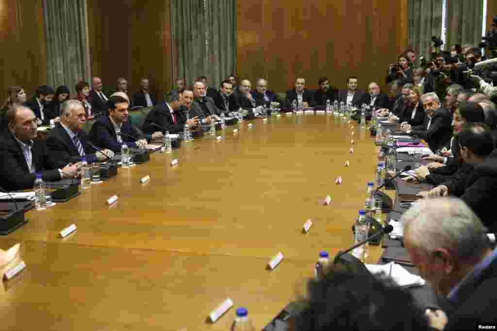 Prime Minister Alexis Tsipras (3rd from left) attends the first meeting of the new cabinet in the parliament building in Athens, Jan. 28, 2015.