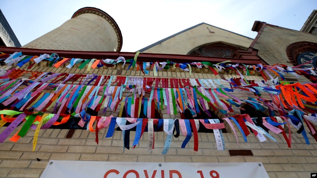 Ribbons hang in remembrance of victims of the coronavirus pandemic outside the Grant African Methodist Episcopal Church, Tuesday, May 19, 2020, in Boston.