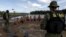 Gold prospectors are detained by agents of Brazil’s environmental agency on the Uraricoera River during an operation against illegal gold mining on indigenous land, in the heart of the Amazon rainforest, in Roraima state, Brazil, April 16, 2016. 