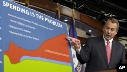 House Speaker John Boehner of Ohio points to a chart to emphasize his point that government spending complicates the negotiations on avoiding the so-called "fiscal cliff" during a news conference in Washington, Dec. 13, 2012.