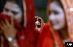 FILE - Pakistani brides attend a mass marriage ceremony in Karachi.