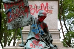 Defaced bronze sculpture on the base of the statue of Confederate general, Albert Pike, after protestors toppled the Pike statue, June 20, 2020, in Washington.