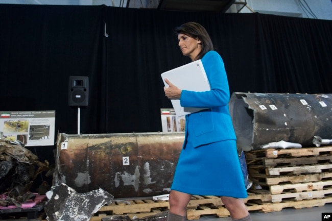 FILE - U.S. Ambassador to the U.N. Nikki Haley walks in front of allegedly recovered segments of an Iranian rocket during a press briefing at Joint Base Anacostia-Bolling, Dec. 14, 2017, in Washington.