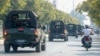 FILE - A convoy of army vehicles patrol the streets in Mandalay, Myanmar, Wednesday, Feb. 3, 2021.