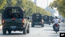 FILE - A convoy of army vehicles patrol the streets in Mandalay, Myanmar, Wednesday, Feb. 3, 2021.