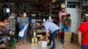 Ainhoa Martinez (L) prepares an order at the Ronda Gourmet shop in downtown Ronda, southern Spain, Sept. 2, 2021. 