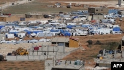 FILE - Tents house Syrian refugees in the city of Arsal in Lebanon's Bekaa valley, near the border with Syria.