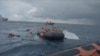 A still image taken from a video shows migrants at sea waiting to be rescued by Spanish search and rescue ship Open Arms during an operation in the Mediterranean Sea, Nov. 11, 2020.