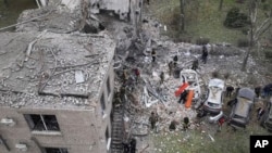 Emergency workers clear the rubble after an overnight Russian attack with guided bombs in Zaporizhzhia, Ukraine, Oct. 21, 2024. (Ukrainian Emergency Service via AP)