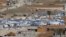 FILE - Tents house Syrian refugees in the city of Arsal in Lebanon's Bekaa valley, near the border with Syria.