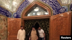 Iraqi Shi'ite cleric Moqtada al-Sadr visits his father's grave after parliamentary election results were announced, in Najaf, Iraq, May 14, 2018. 