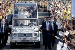 Pope Francis arrives on his pope-mobile to celebrate a Byzantine rite Mass at Mestska sportova hala Square, in Presov, Slovakia, Tuesday, Sept. 14, 2021.