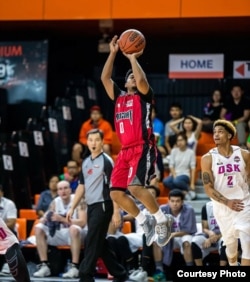 Dominic Dar, a player on Cambodia's national basketball team, takes a shot.